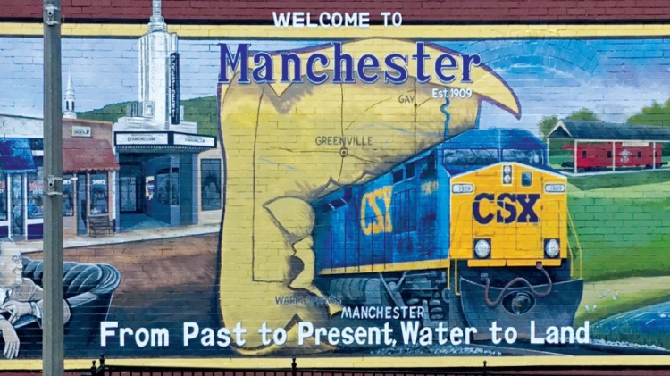 brick mural of a CSX train in Manchester, GA